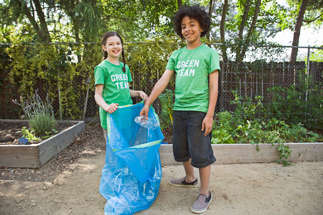 Children with plastic bag for litter